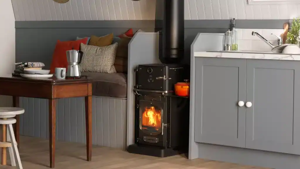 A professional installation of a Go Eco Adventurer 5 multi-fuel stove in a narrowboat, featuring its large viewing window and compact marine hearth kit.