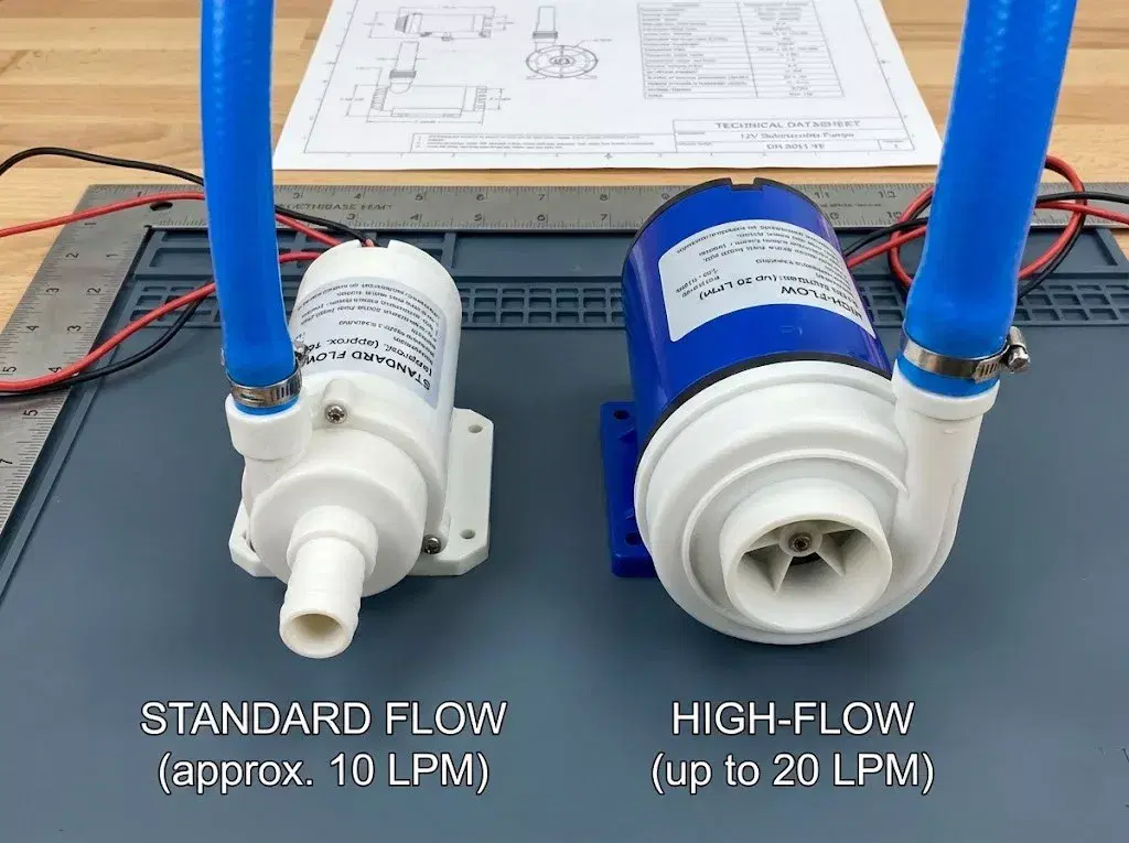 A technical comparison shot showing a compact standard flow 12V submersible pump next to a larger high-flow variant, highlighting the difference in motor and impeller housing.