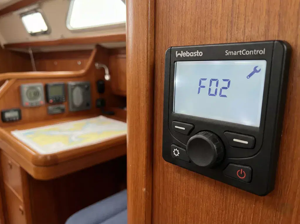 A close-up shot of a Webasto SmartControl digital interface mounted on a boat cabin wall, displaying a technical error code for system diagnostics.