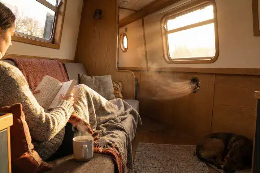 A warm narrowboat cabin interior with a subtle heating vent, illustrating the comfort provided by diesel air heaters.