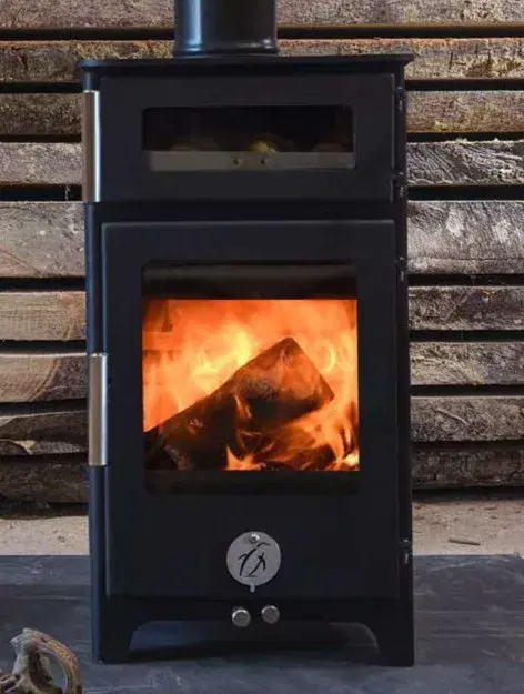 Hungry Penguin multi-fuel stove with the top oven door open showing a baking tray inside.