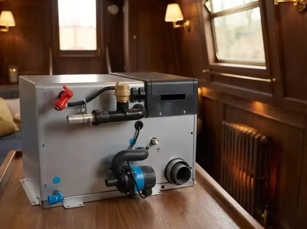 An Alde Compact 3030 marine boiler sitting on a workshop counter before installation, showing the pump, plumbing ports, and flue outlet.