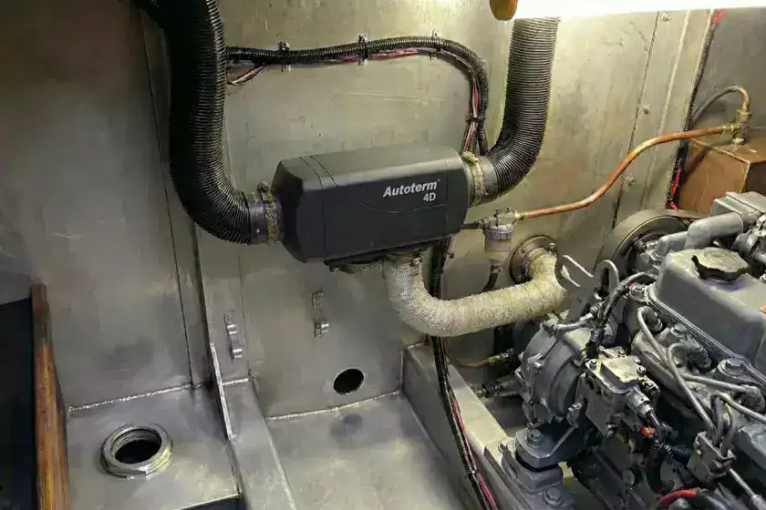 Professional installation of a high-capacity Autoterm 4D diesel heater in a narrowboat engine bay with top-routed air ducting and clear fuel filter.