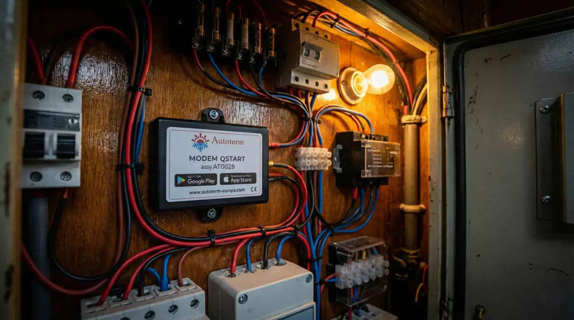 Autoterm QSTART Modem installed on a wooden wall inside a narrowboat electrical cupboard alongside marine wiring and breakers.