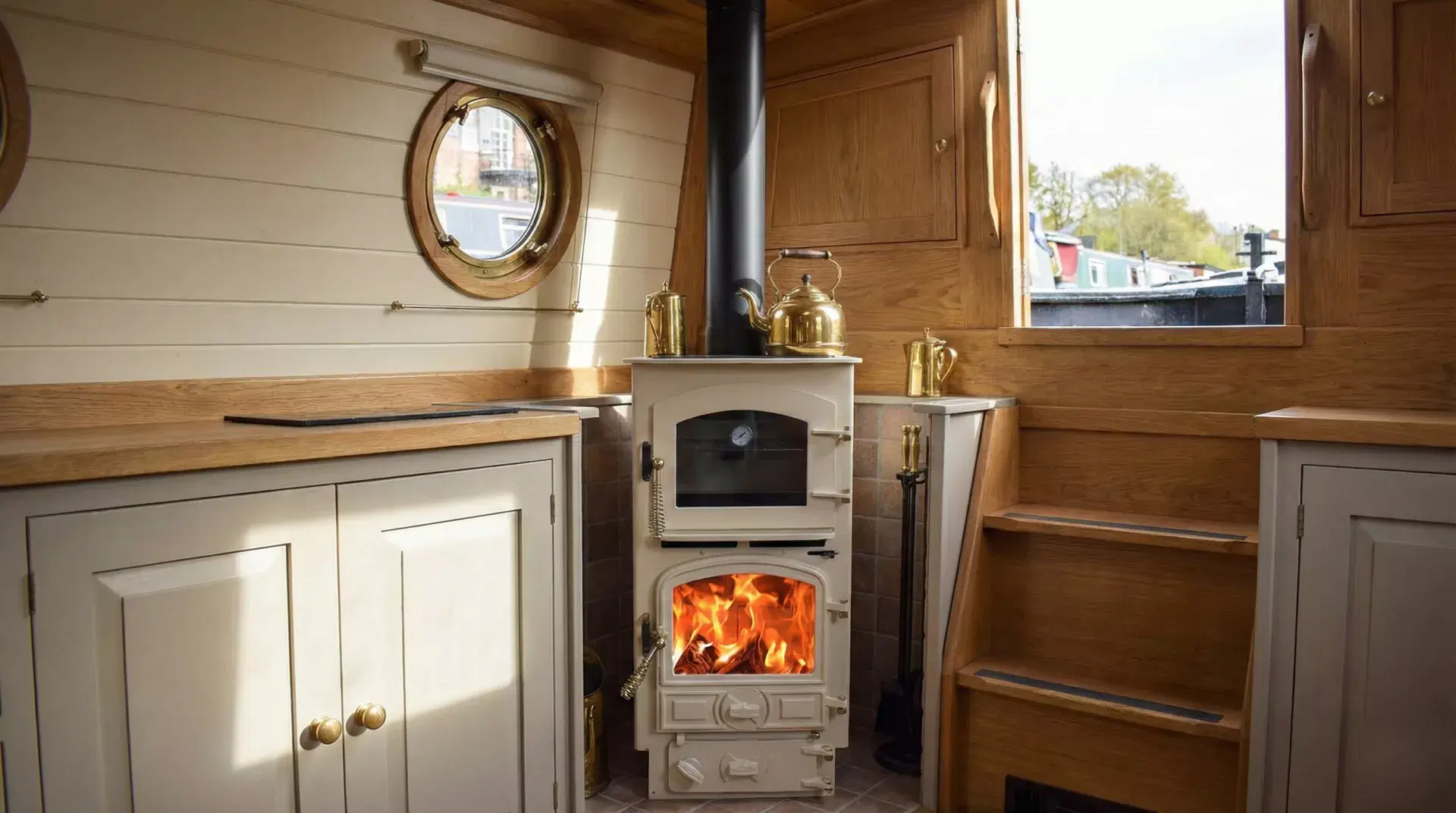 Cream Bubble 4B Pie Pod 2 multi-fuel stove installed in a narrowboat cabin with a black twin-wall insulated flue and brass accessories.