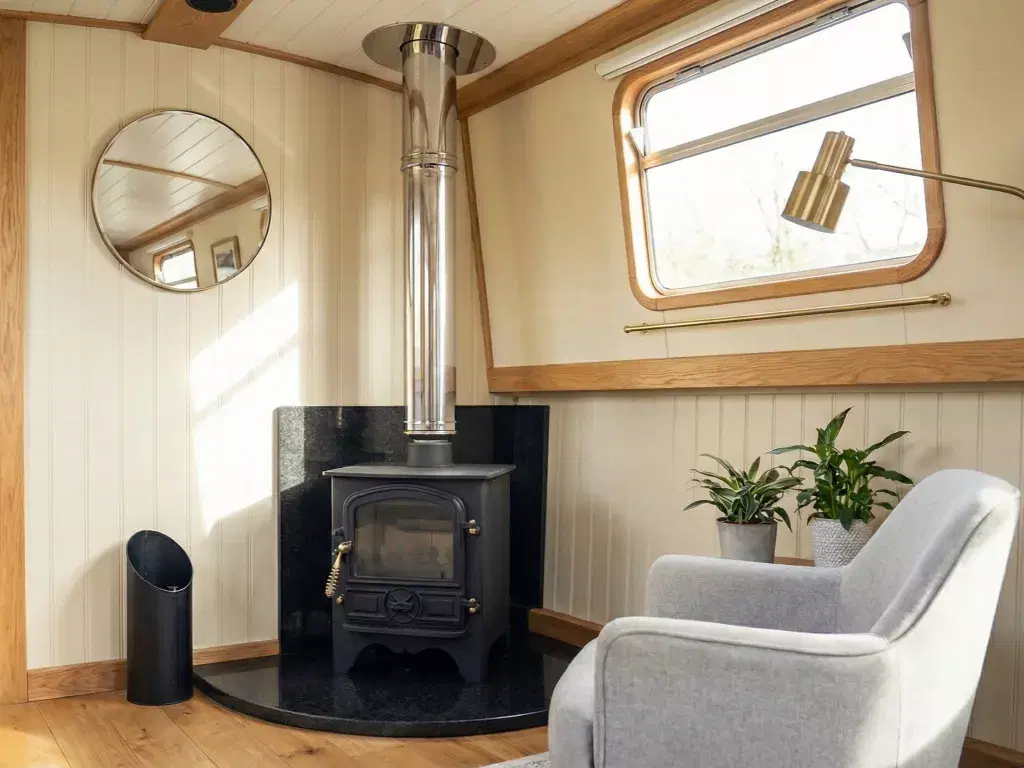 Bubble B1 Diesel boat stove with a silver stainless steel twin-wall insulated flue, installed without a fiddle rail in a modern narrowboat cabin.