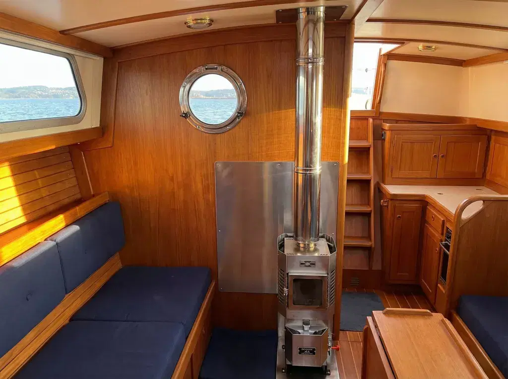 Professional installation of a Dickinson Alaska diesel stove in a boat cabin by OFTEC-certified Marine Heating Solutions engineers