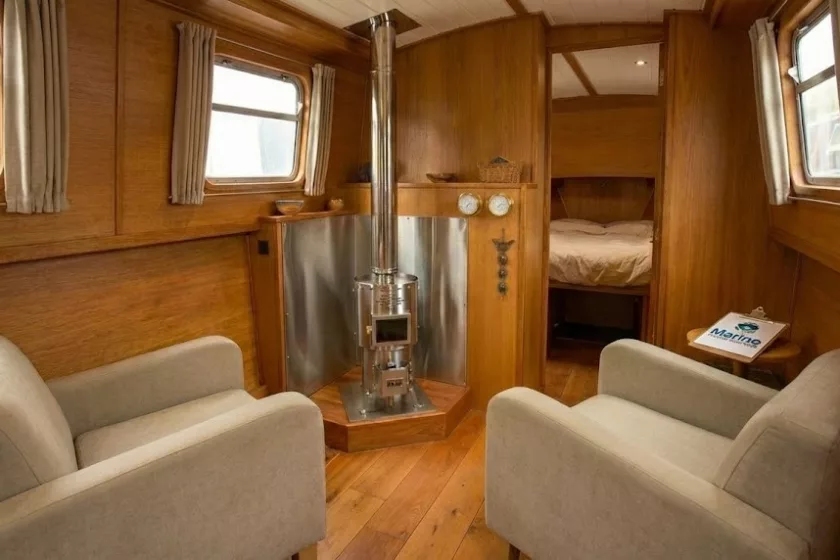 Dickinson Antarctic floor-mounted diesel boat stove installed in a cozy wood-paneled cabin by Marine Heating Solutions.