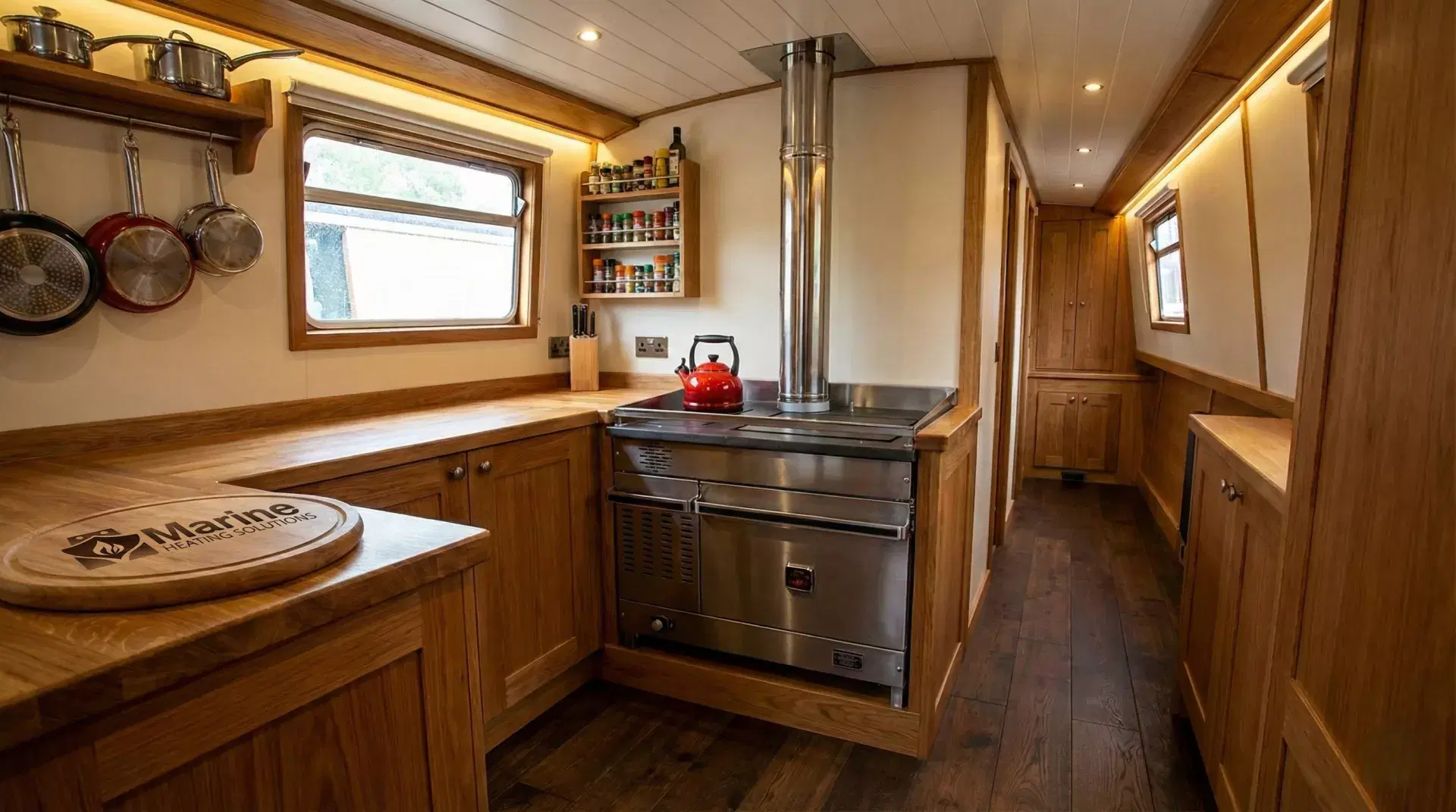 Professional installation of a Dickinson Atlantic marine diesel cooker in a narrowboat galley with a 15cm oak plinth and a vertical stainless steel flue.