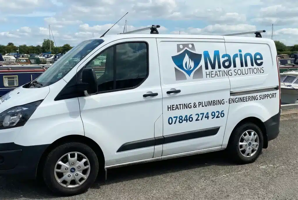 Van displaying Marine Heating Solutions livery and contact phone number 07846 274 926 parked at a marina.