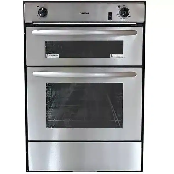 Front view of the Thetford Midi Prima 7200 built-in LPG oven and grill with a stainless steel silver finish and black control knobs.