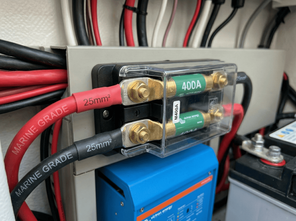 Close-up of professional 25mm² marine grade battery cables connected to a 400A Mega Fuse holder for a 3000W inverter circuit.