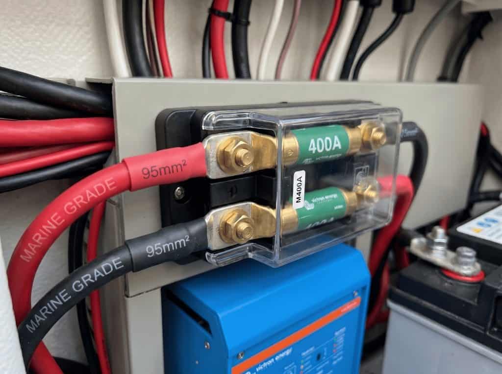 Close-up of professional 95mm² marine grade battery cables connected to a 400A Mega Fuse holder for a 3000W inverter circuit.