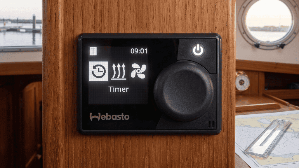 Close-up of a Webasto MultiControl digital timer interface for a marine diesel heater, professionally mounted on a boat bulkhead.